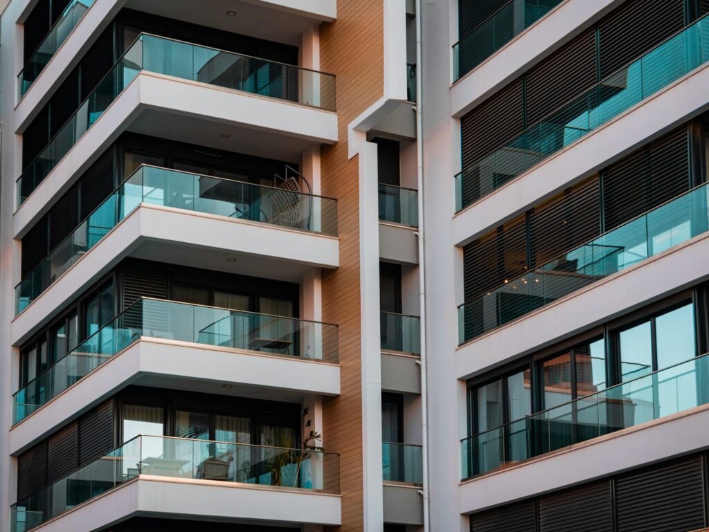 Contemporary architecture showcasing glass balconies and sleek design.